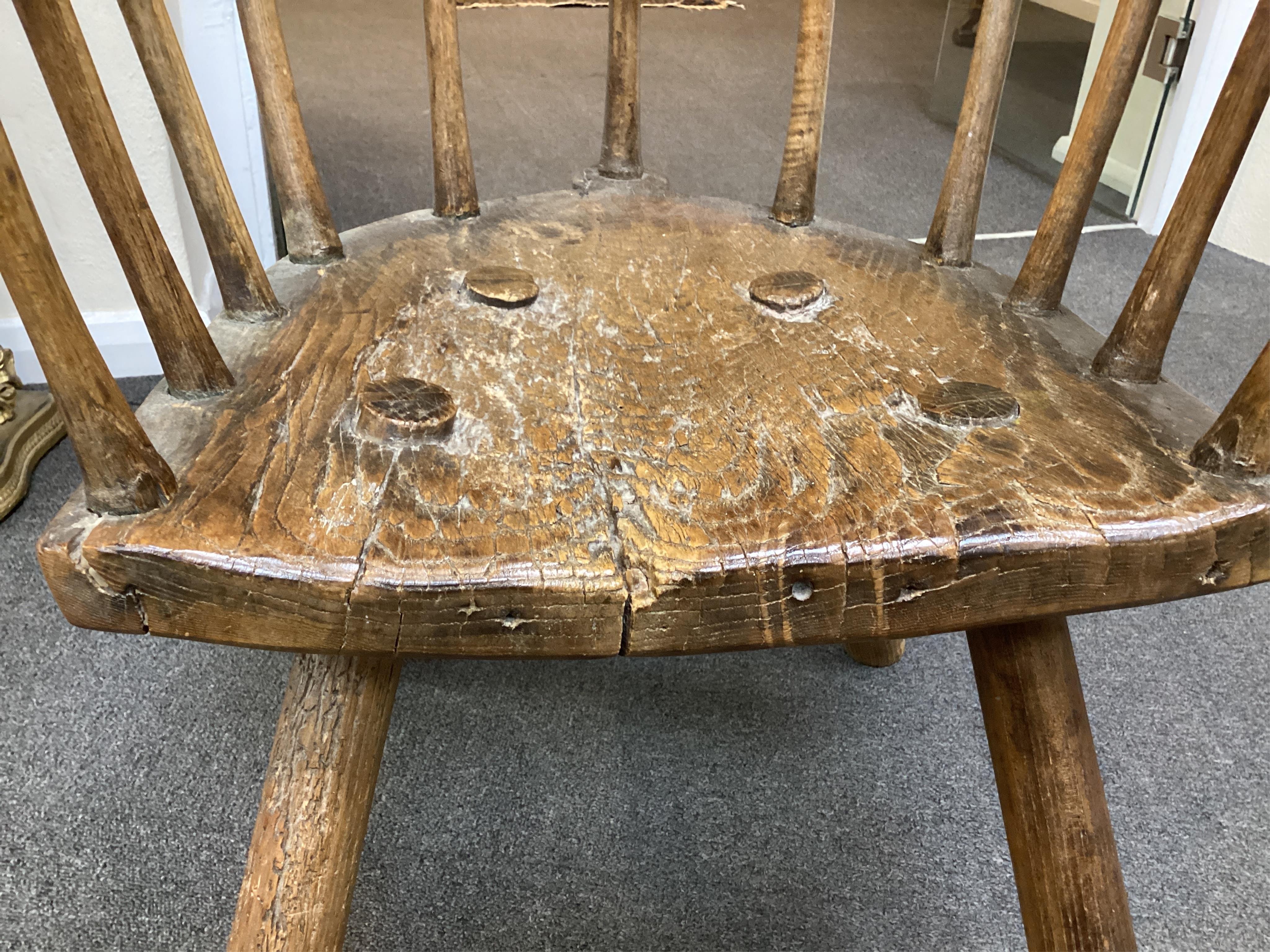 An 18th or 19th century primitive ash and elm Windsor armchair